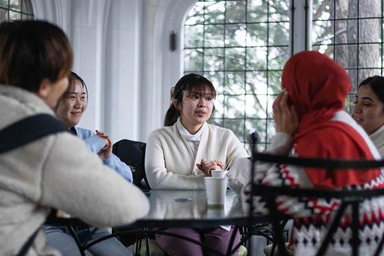 Photo of a group of international students seated in a room at 波胆网站, talking together